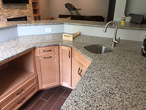 Remodeled kitchen with speckled granite countertop and red ceramic tile in Rochester, MN