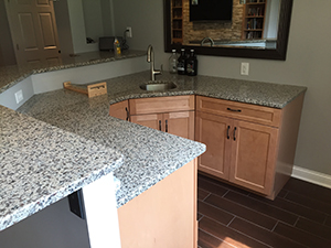 Remodeled basement kitchen with speckled granite countertop in Rochester, MN