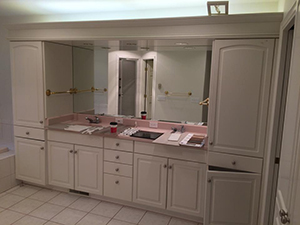 Master bath with old ugly white cabinets and pink countertop before remodel