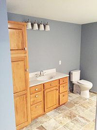 New bathroom build with newly installed cabinetry, vanity, and toilet in Rochester, MN